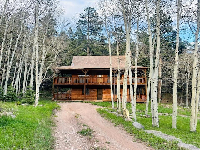 834 Ponderosa Rd, Cuchara, CO 81055 - view of front of house with driveway, a deck, and a shingled roof