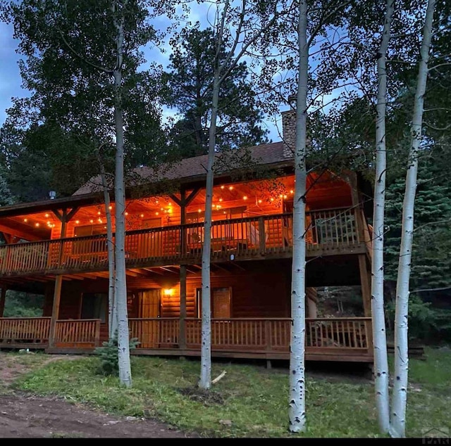 834 Ponderosa Rd, Cuchara, CO 81055 - back of house with a wooden deck, faux log siding, and a chimney