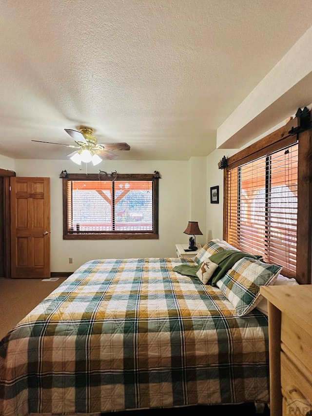 834 Ponderosa Rd, Cuchara, CO 81055 - carpeted bedroom featuring a textured ceiling, a ceiling fan, and baseboards
