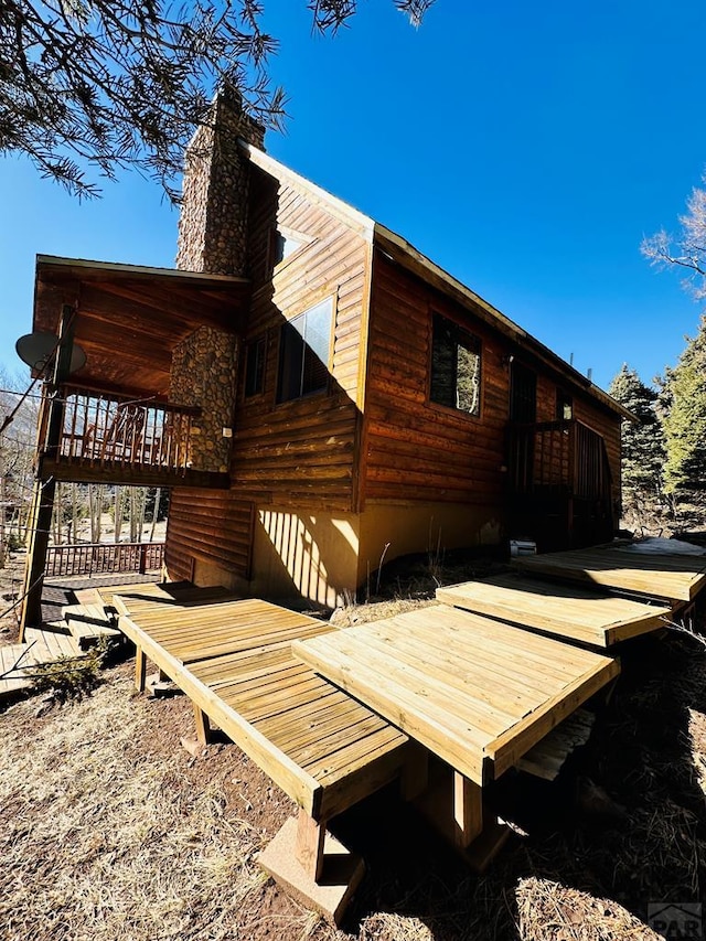 834 Ponderosa Rd, Cuchara, CO 81055 - view of side of property with a chimney and a deck