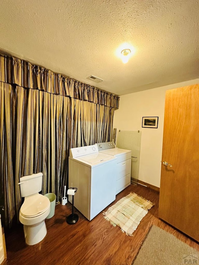 834 Ponderosa Rd, Cuchara, CO 81055 - laundry room with separate washer and dryer, wood finished floors, a textured ceiling, and baseboards