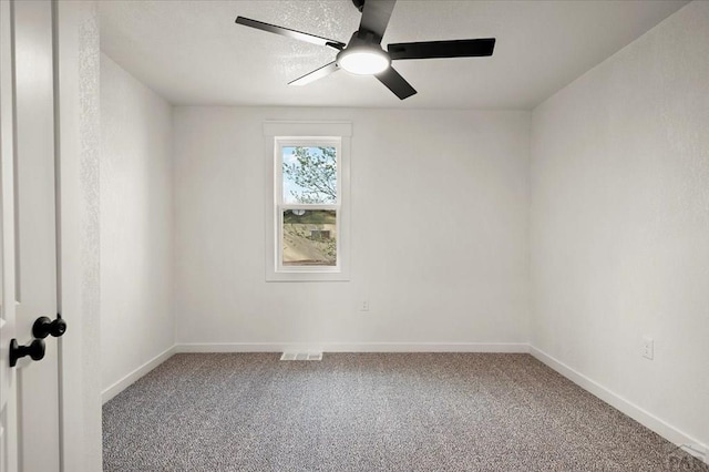 carpeted empty room with a ceiling fan and baseboards