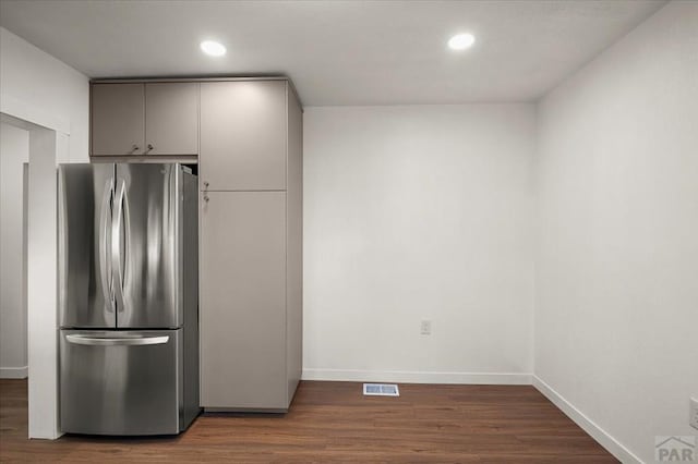 kitchen with freestanding refrigerator, gray cabinetry, dark wood finished floors, recessed lighting, and baseboards