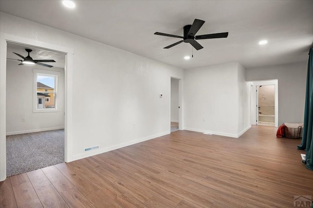 empty room with ceiling fan, light wood-style flooring, baseboards, and recessed lighting