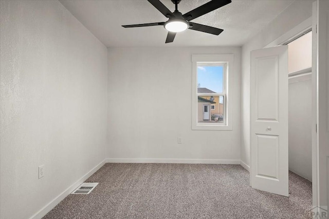 unfurnished bedroom featuring carpet, baseboards, and ceiling fan