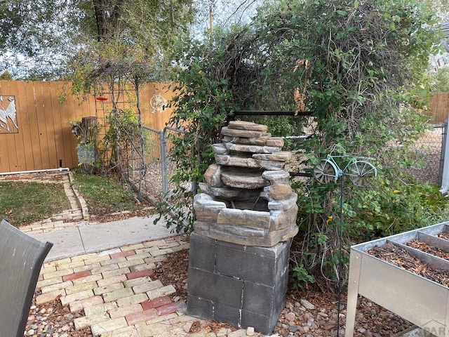 exterior space featuring a garden and fence private yard