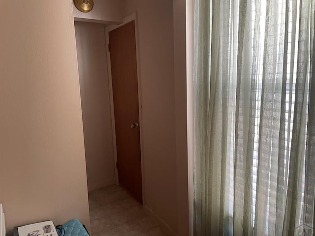 corridor featuring tile patterned flooring