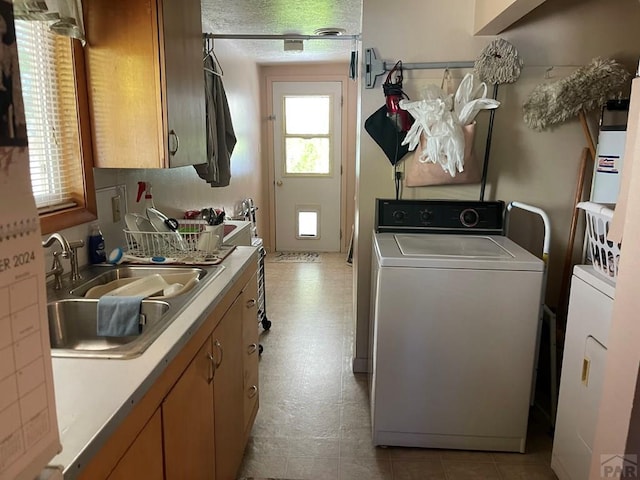 laundry room featuring a sink, washer / dryer, and laundry area