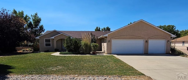 view of front of house with a front lawn, driveway, stucco siding, and an attached garage