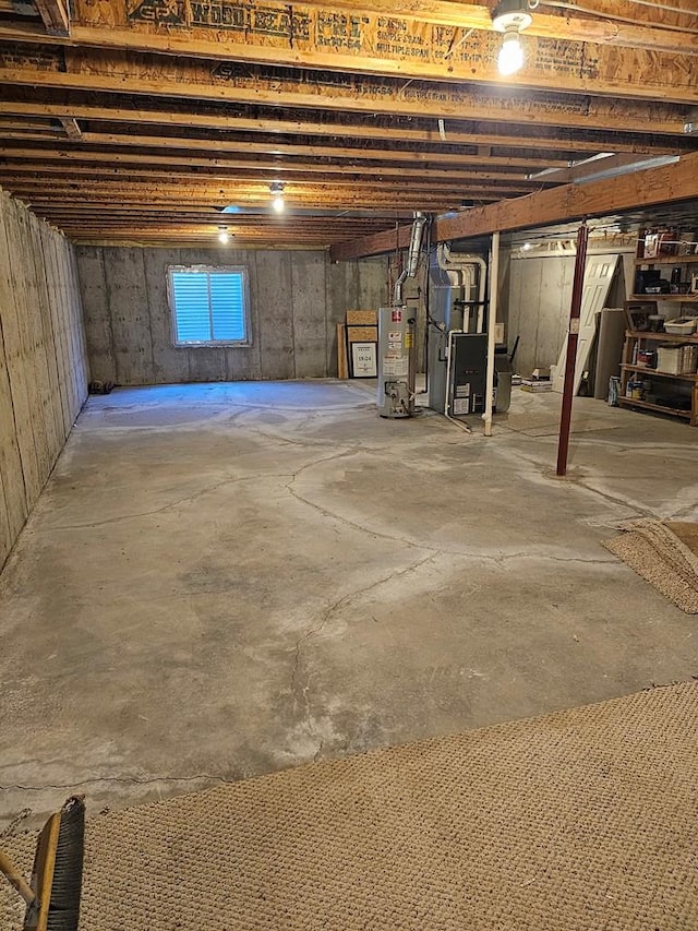 unfinished basement with water heater and heating unit
