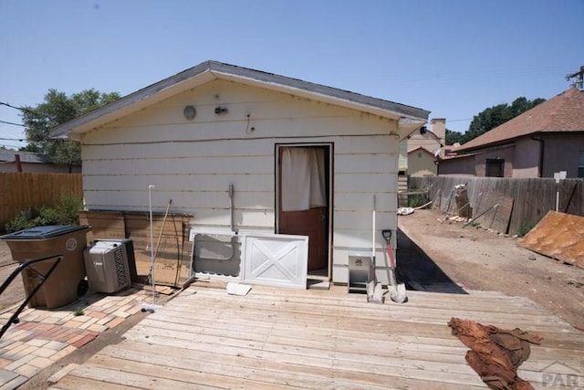 view of outbuilding featuring fence