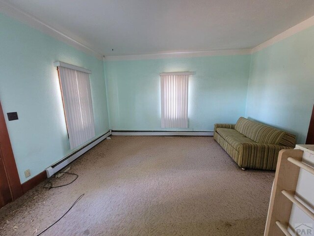 unfurnished living room featuring a baseboard radiator, baseboard heating, and carpet flooring