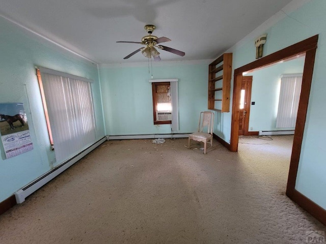 spare room featuring a baseboard heating unit and a wealth of natural light