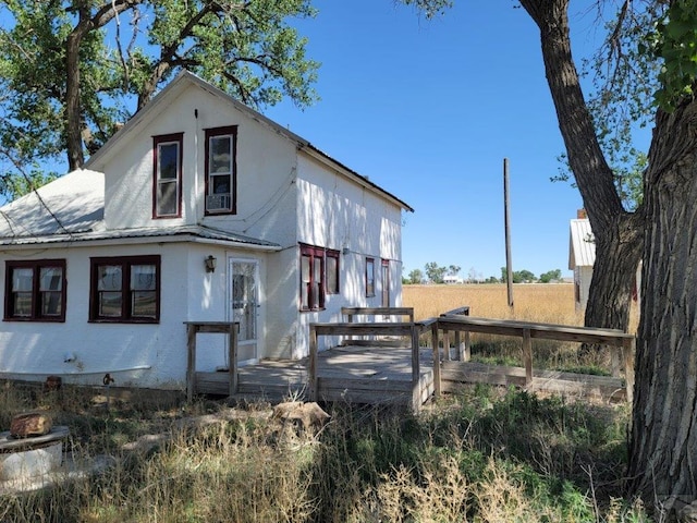 view of home's exterior with metal roof and a deck