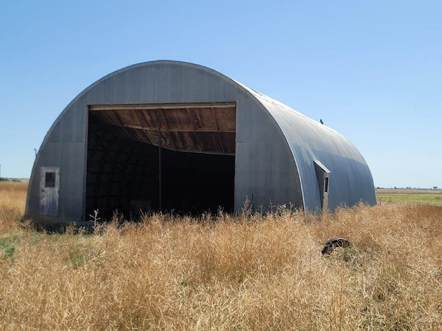 view of outbuilding with an outbuilding and a rural view