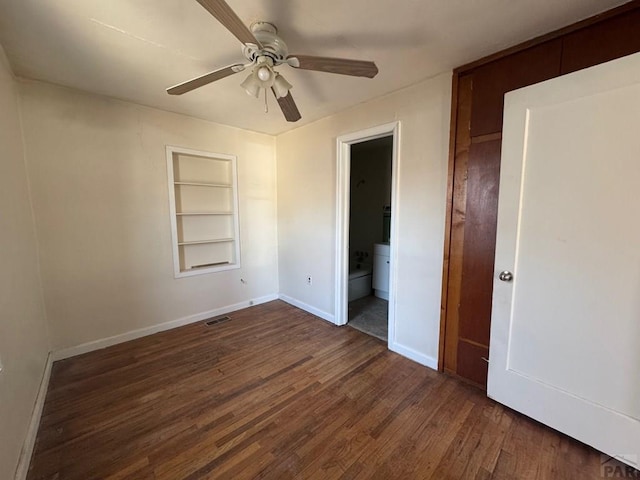 303 8th St, Fowler, CO 81039 - unfurnished bedroom with baseboards, dark wood finished floors, a ceiling fan, and ensuite bathroom