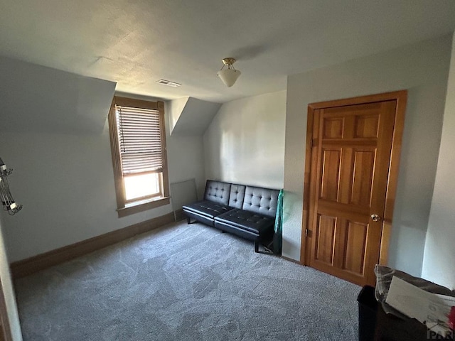 additional living space with carpet floors, visible vents, lofted ceiling, and baseboards