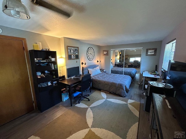 bedroom featuring freestanding refrigerator and wood finished floors