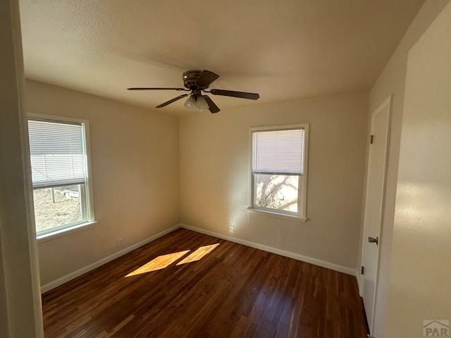 unfurnished room featuring ceiling fan, baseboards, and wood finished floors