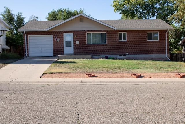 ranch-style home with a garage, brick siding, concrete driveway, roof with shingles, and a front lawn