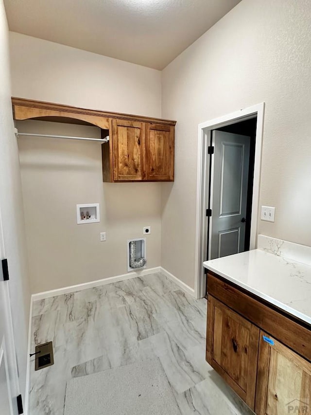 clothes washing area with cabinet space, baseboards, marble finish floor, washer hookup, and electric dryer hookup