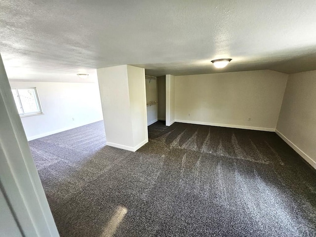 802 E 5th St, Florence, CO 81226 - basement featuring dark carpet, a textured ceiling, and baseboards