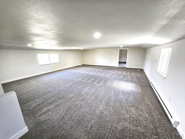 802 E 5th St, Florence, CO 81226 - below grade area with a textured ceiling, carpet flooring, baseboard heating, and baseboards