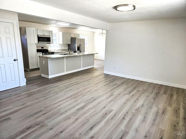 802 E 5th St, Florence, CO 81226 - kitchen with a sink, wood finished floors, and stainless steel appliances