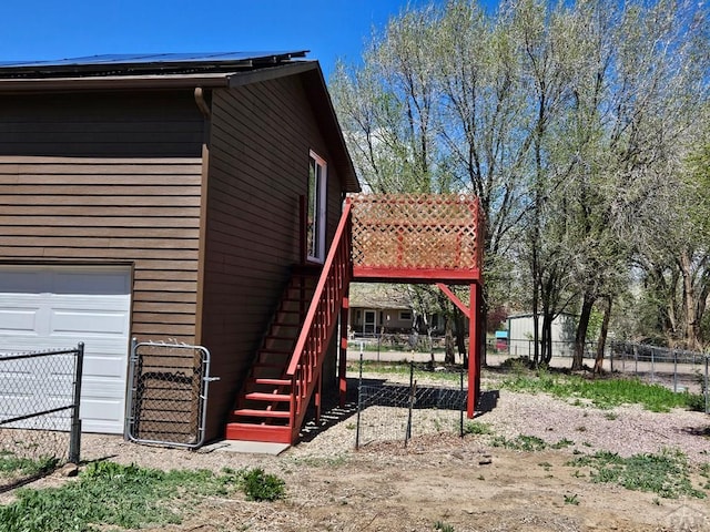 802 E 5th St, Florence, CO 81226 - view of side of property with a garage, stairway, and fence