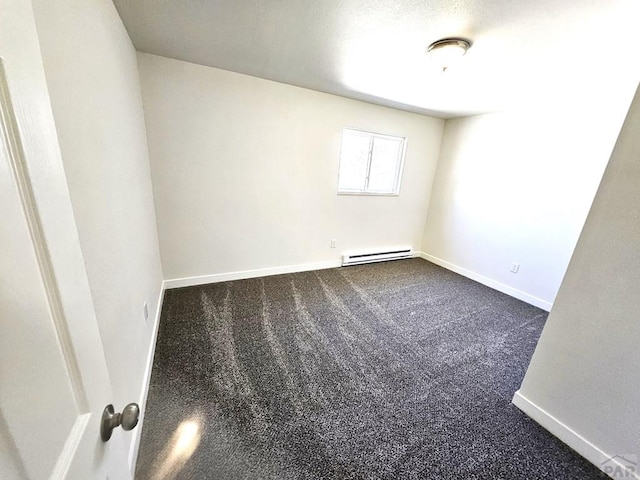 802 E 5th St, Florence, CO 81226 - spare room with dark colored carpet, baseboard heating, and baseboards