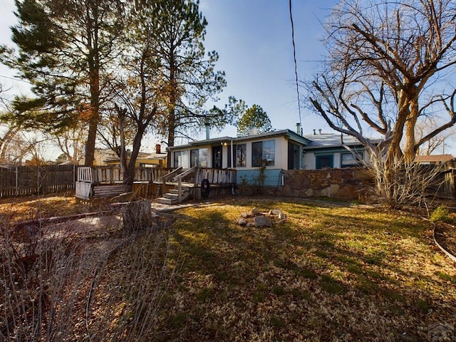 exterior space with fence and a front yard