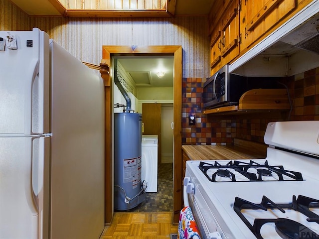 kitchen with white appliances, light countertops, and gas water heater