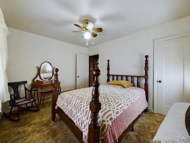 bedroom featuring dark carpet and a ceiling fan