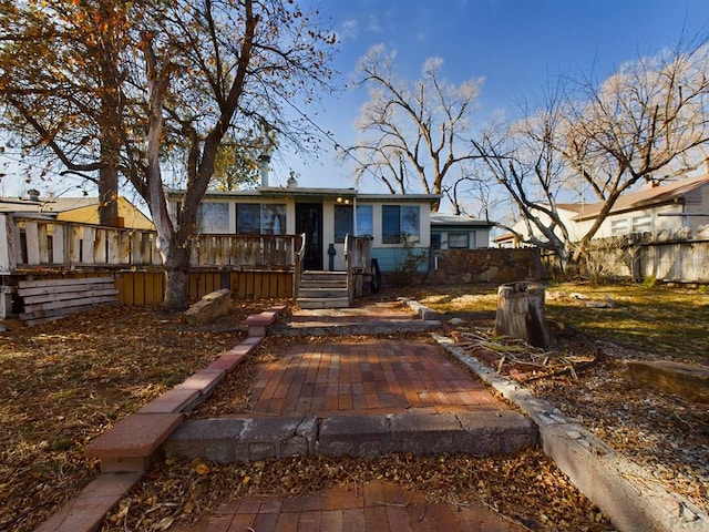 view of front facade featuring fence