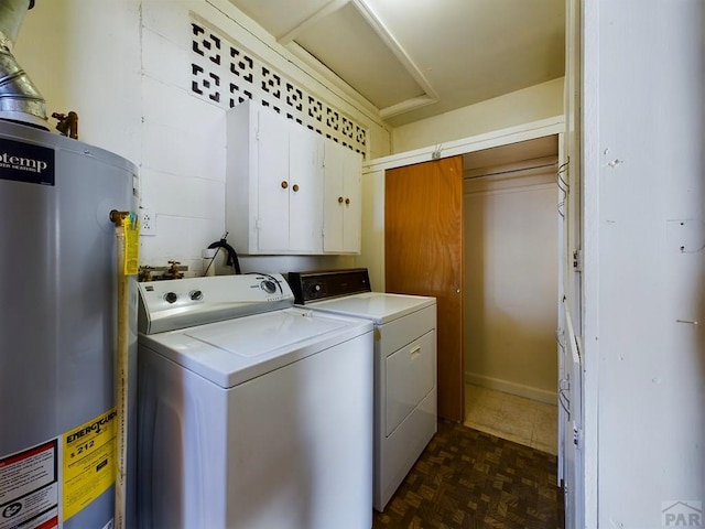 laundry area featuring water heater, cabinet space, and washer and dryer