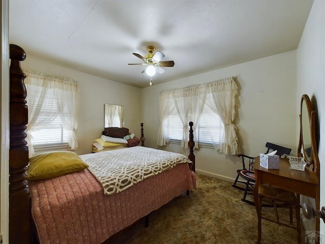 bedroom featuring baseboards, dark carpet, and a ceiling fan