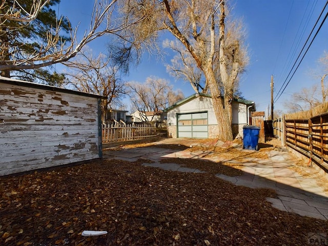 view of yard with an outdoor structure and fence