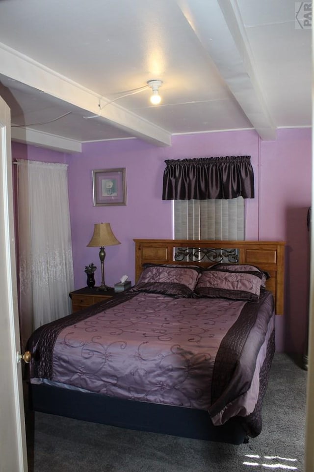 carpeted bedroom featuring beam ceiling