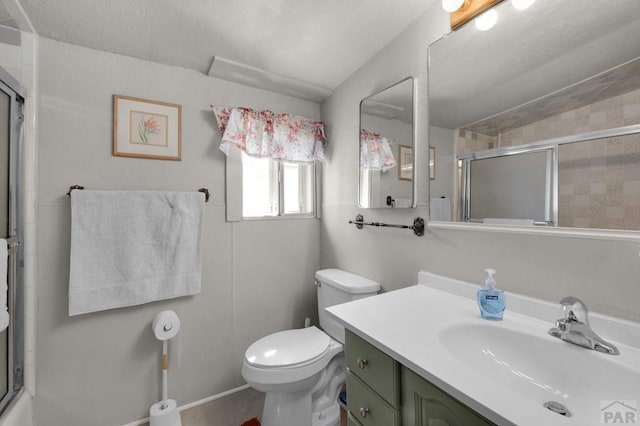 full bathroom featuring a shower with door, vanity, and toilet