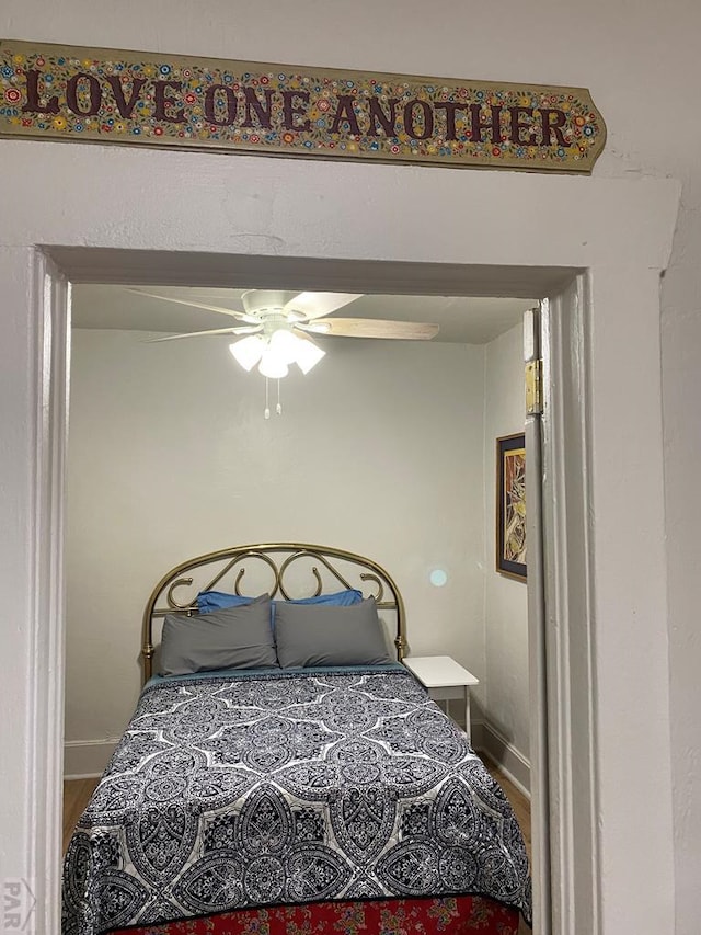 bedroom featuring wood finished floors and baseboards
