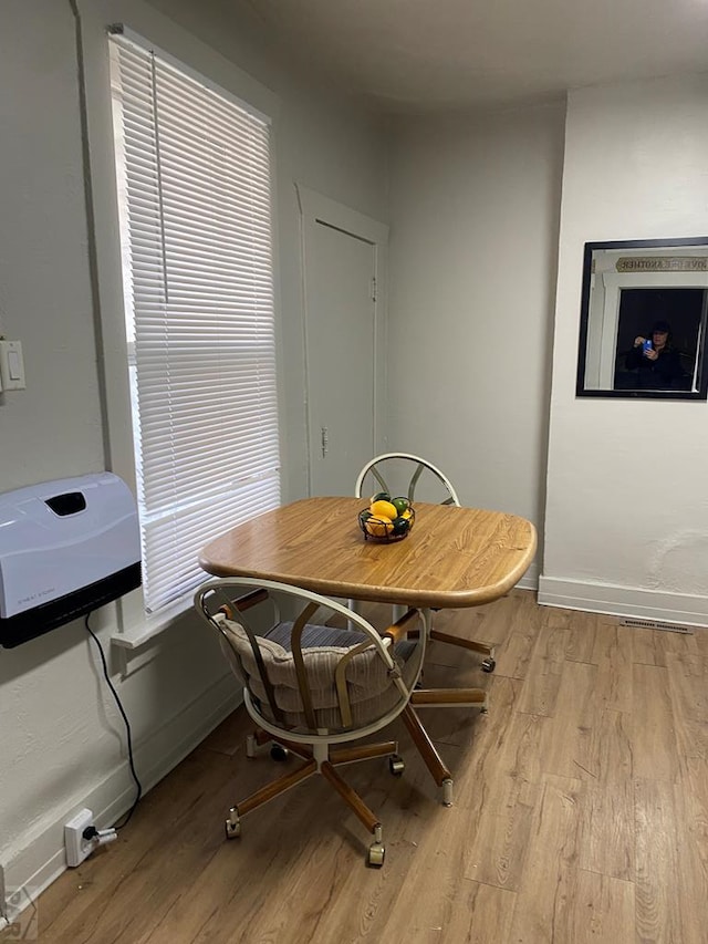 dining area featuring baseboards and wood finished floors