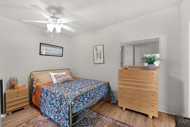 bedroom featuring wood finished floors and a ceiling fan