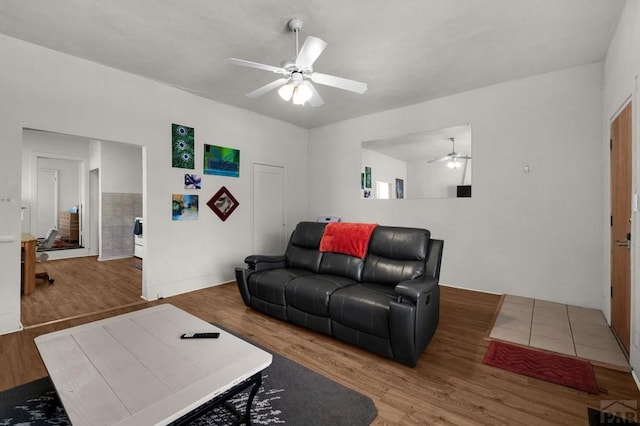 living room featuring ceiling fan and wood finished floors