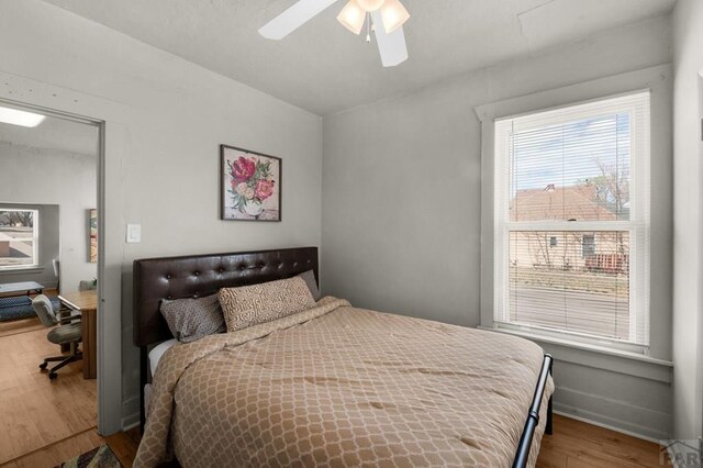 bedroom with a ceiling fan and wood finished floors