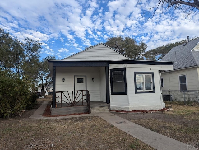 bungalow-style home with a porch and fence