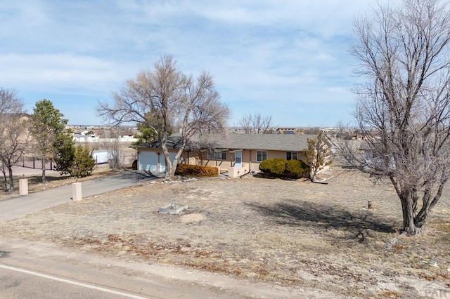 single story home featuring an attached garage and driveway