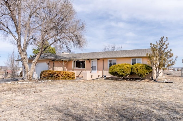 single story home with stucco siding and an attached garage