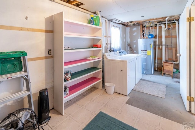 interior space with washer and dryer, laundry area, light floors, and water heater