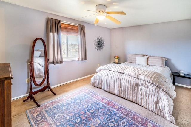 carpeted bedroom featuring a ceiling fan and baseboards