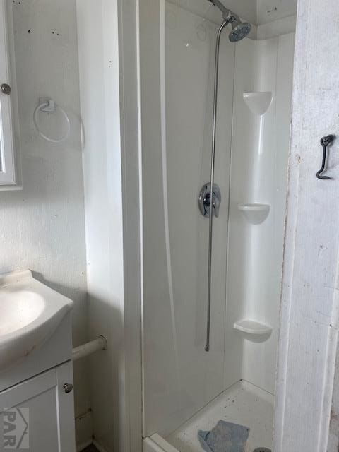 bathroom featuring a stall shower and vanity